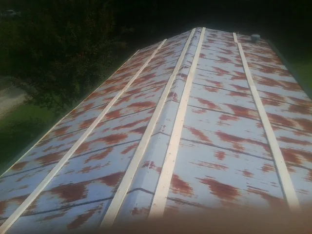 Rusted metal roof panels with new wood purlins before replacement — Storm Damage Roof Repair in Thorntown by Roofing Brothers