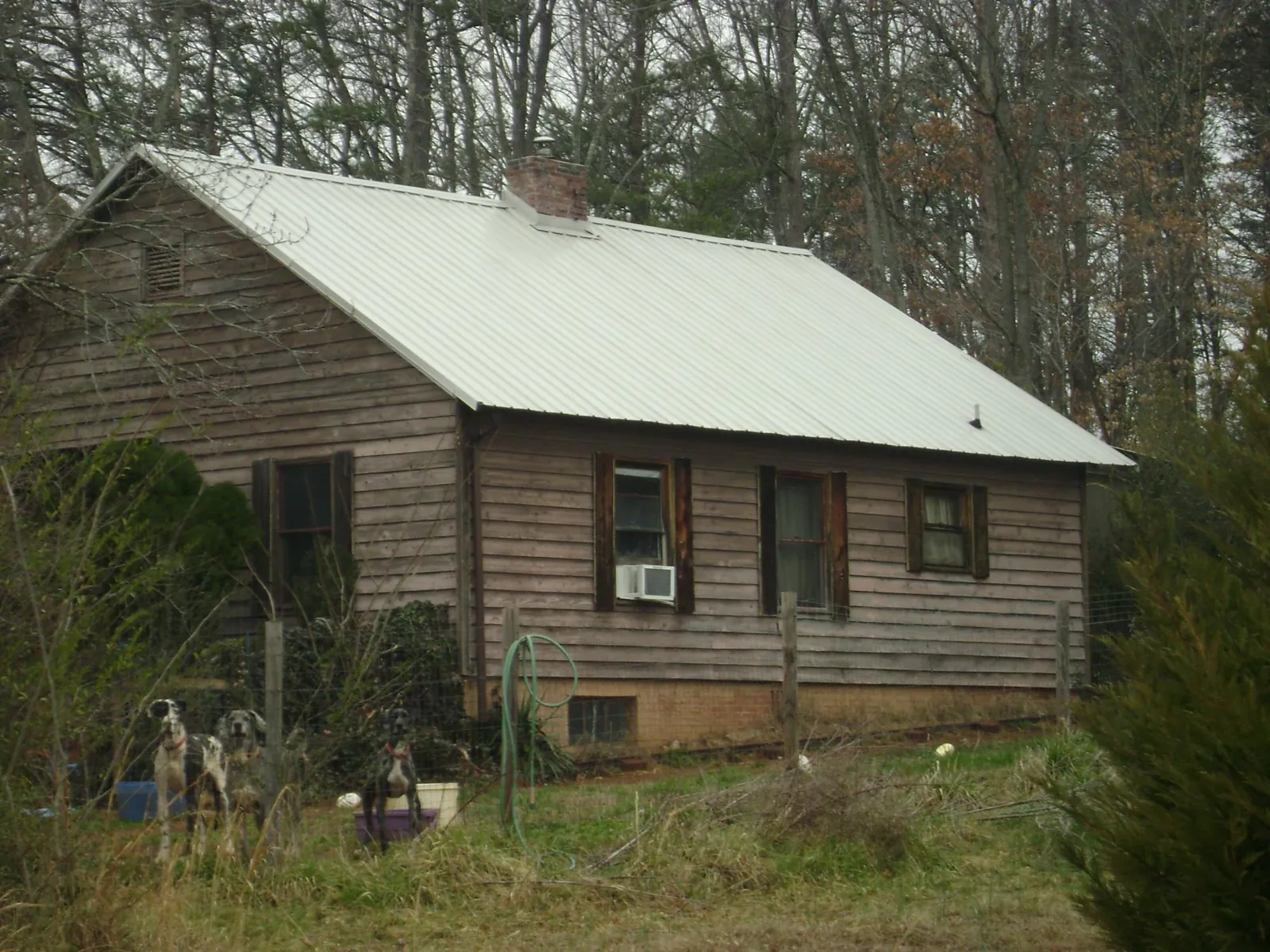 White metal roof on an old wood sided farmhouse, from a Metal Roof Installation job in Thorntown